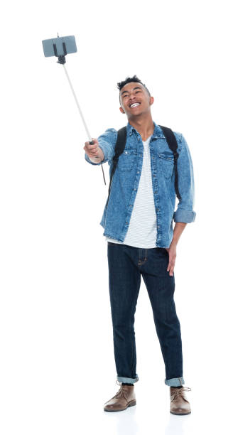 istock Attractive young male holding a selfie stick 925211556