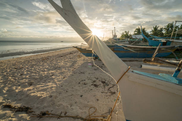 istock Fishing boat on tropical beach at sunset, Philippines 925211954