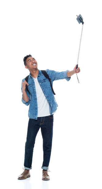istock Attractive young male holding a selfie stick 925212444