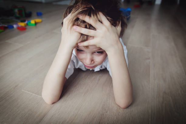 istock sad child, stress and depression at home 925214814
