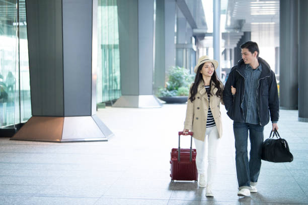 istock Men and women walking with arms folded. 925214966