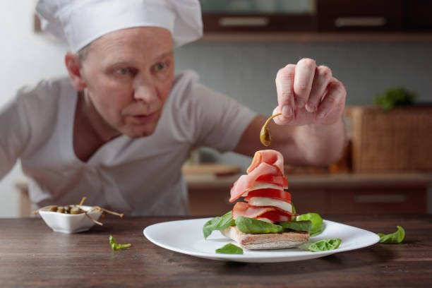 Chef prepares a snack with mozzarella and smoked meat . Selective focus .
