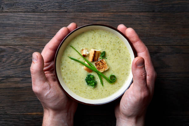 istock French cream soup with mushroums in man hand . 925218654