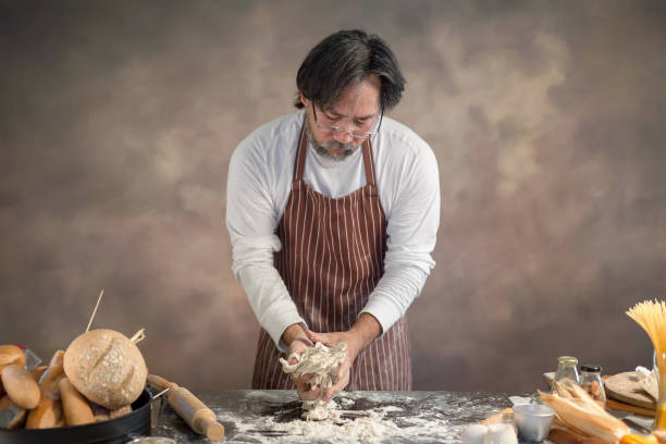 Chef hipster stylish kneads dough for bread on wooden board