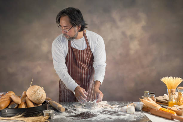 istock Chef hipster stylish kneads dough for bread on wooden board 925220142
