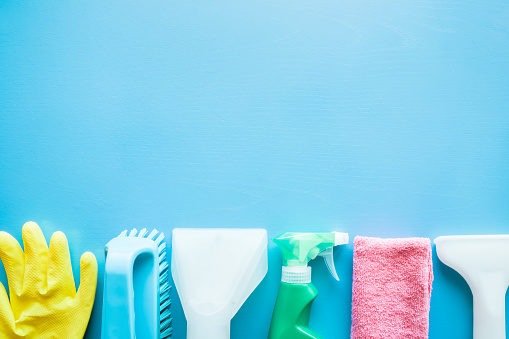 Vacuum cleaner nozzle and colorful cleaning set for different furniture surfaces in house. Dry cleaning service concept. Early spring regular clean up. Empty place for text or logo on blue background.