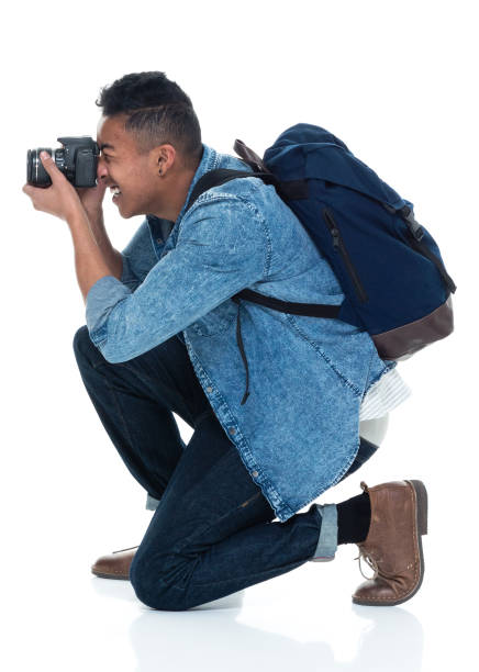 istock Young male photographer crouching and with camera 925223560