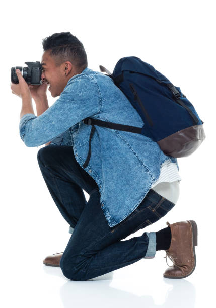 istock Young male photographer crouching and with camera 925224368