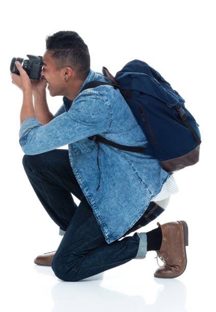 istock Young male photographer crouching and with camera 925224576