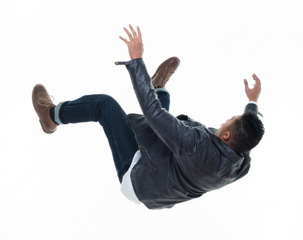 Daring young handsome male in mid air falling and jumping stock photo