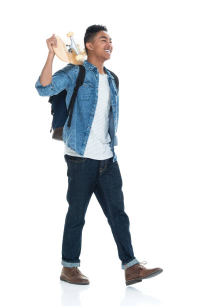 istock Attractive young male holding a skateboard and walking 925225662