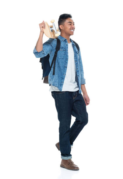 istock Attractive young male holding a skateboard and walking 925225892