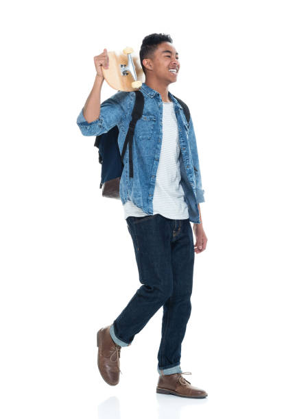 istock Attractive young male holding a skateboard and walking 925226498