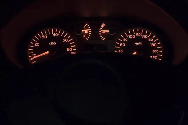 Dashboard of a car shot a night with text area