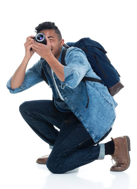 istock Young male photographer crouching and with camera 925231080