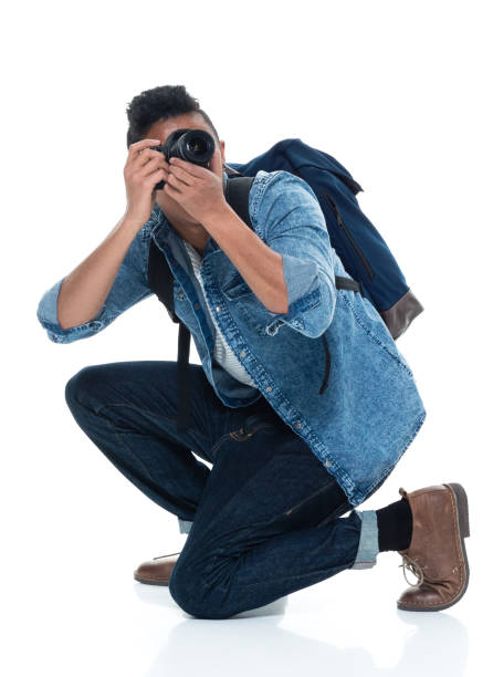 istock Young male photographer crouching and with camera 925231092