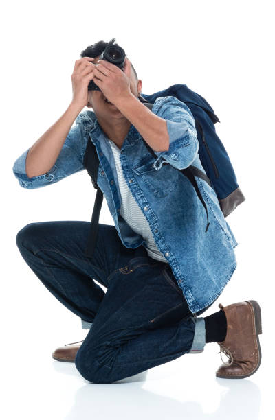 istock Young male photographer crouching and with camera 925231168