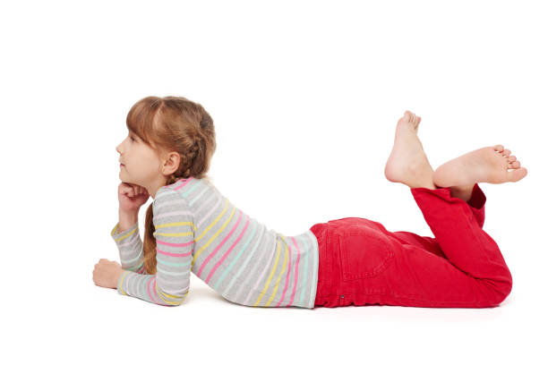 istock Child girl lying on the floor looking forward 925232752