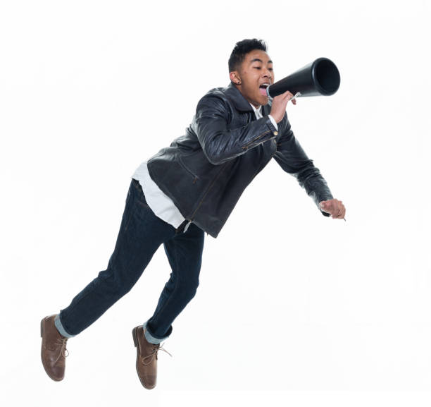 istock Daring young handsome male in mid air and reading a book 925233078