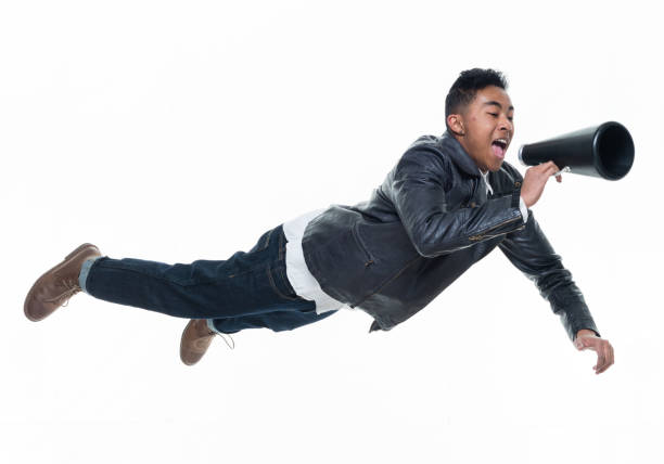 istock Daring young handsome male in mid air and reading a book 925235268