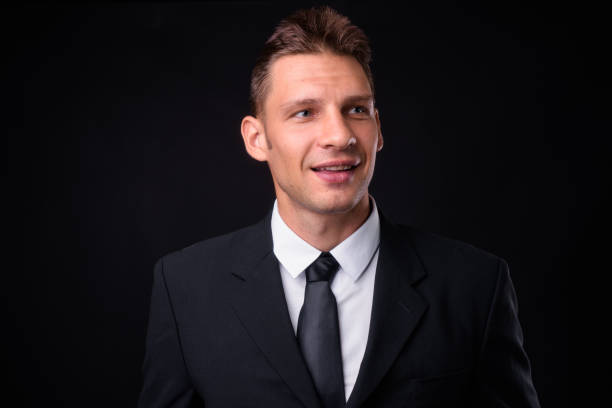 istock Handsome businessman against black background 925235568