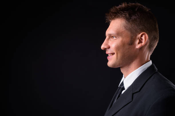 istock Handsome businessman against black background 925235620