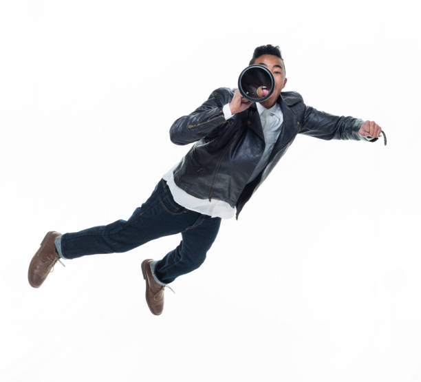 istock Daring young handsome male in mid air and reading a book 925236752