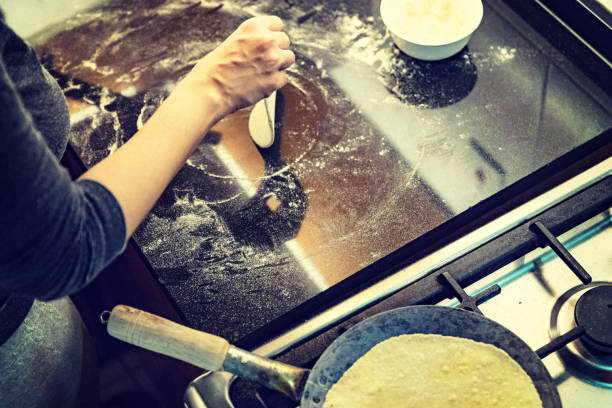 istock Flipping a chapati while another is cooking on the pan. 925236836