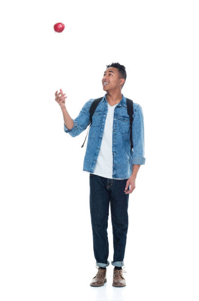 istock Handsome young male student holding an apple 925236866