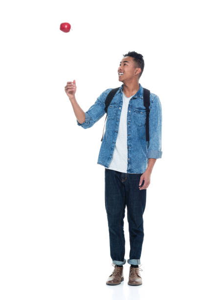istock Handsome young male student holding an apple 925236946