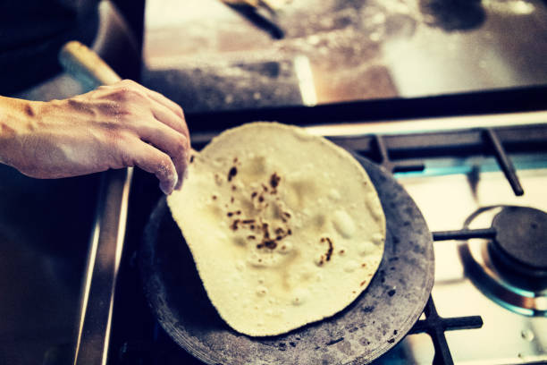 Lifting a hot chapati from a pan
