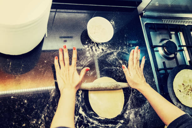 istock Over the counter view of chapatis being prepared 925239330