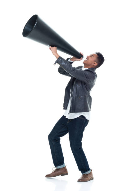 istock Dashing young man holding a large megaphone 925239676