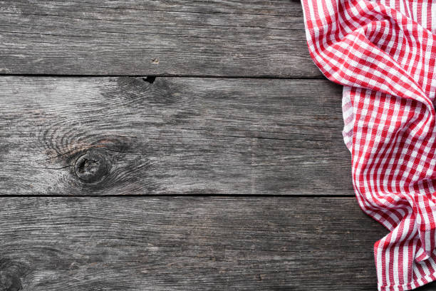 istock Red checkered textile on rustic wood. Food background 925239842