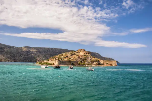 Spinalonga Crete sea boats Venetian fortress ruins leper colony landscape from Plaka