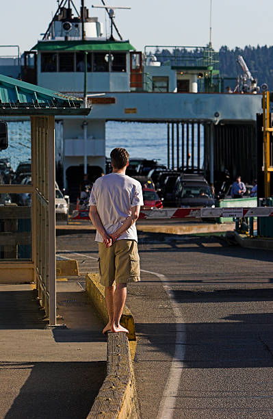 Young man waiting for a car ferry stock photo