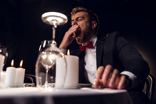 istock tired man yawning and waiting for romantic date in restaurant 925244496
