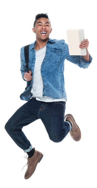 istock Hip young male student holding books and jumping 925245246