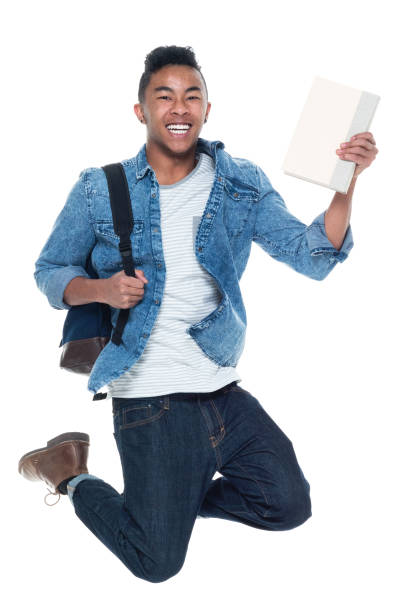 istock Hip young male student holding books and jumping 925245276