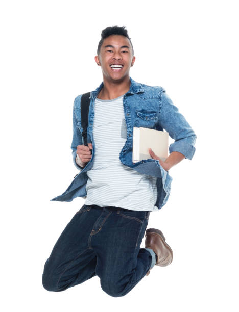 istock Hip young male student holding books and jumping 925245420