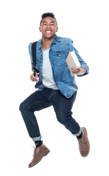 istock Hip young male student holding books and jumping 925247498