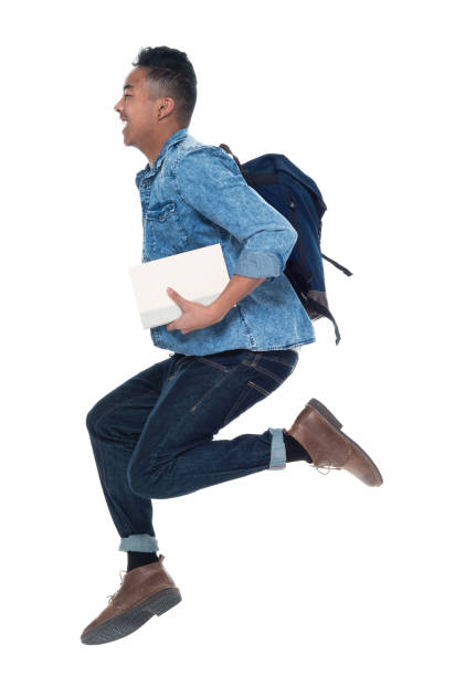 istock Hip young male student holding books and jumping 925247572