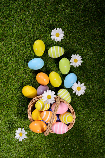 istock above top view of multi colored painted easter eggs on the green grass with springtime daisy flowers 925247698