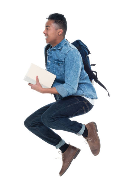 istock Hip young male student holding books and jumping 925247834