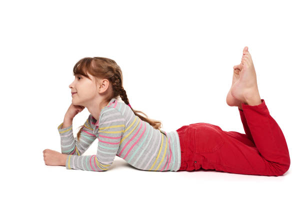 istock Child girl lying on the floor looking forward 925247958