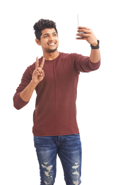 istock Attractive Indian young man taking selfie in mobile phone 925248392