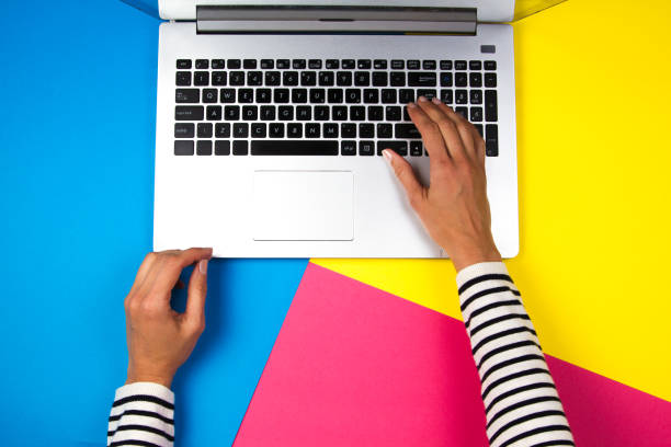istock Woman hands using laptop on colorful background 925248586