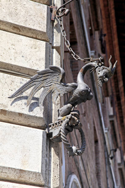 istock Medieval architectural detail with devil figure in Siena, Italy. 925248928