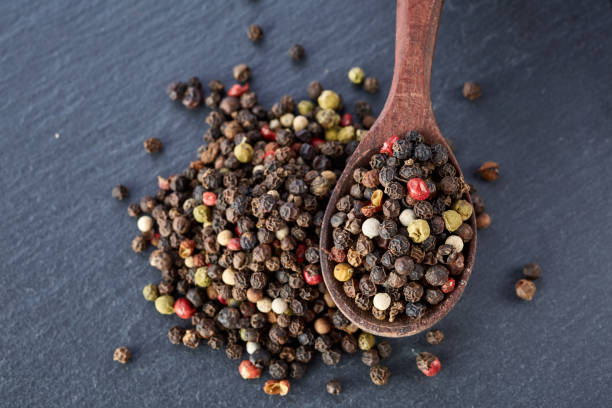 istock black pepper peas in a spoon on a stone background 925255860