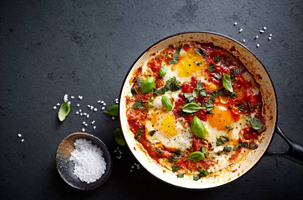 Shakshouka Eggs (poached eggs in a spicy tomato sauce) Shakshouka Eggs (poached eggs in a spicy tomato sauce) middle eastern food photos stock pictures, royalty-free photos & images